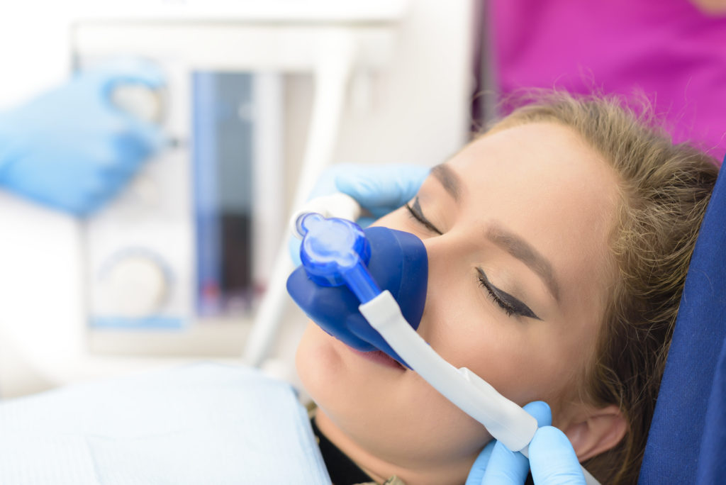 patient asleep during a dental procedure thanks to laughing gas sedation